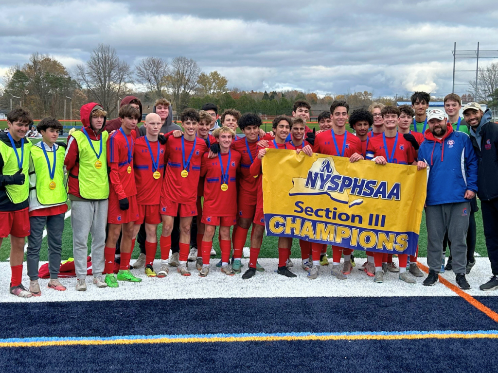 boys soccer team holding the section III championship banner