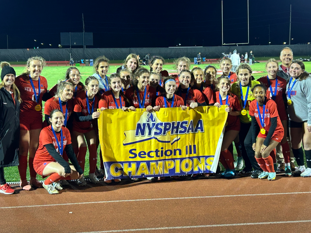 girls soccer team holding the section III championship banner